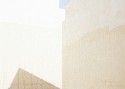a man riding a skateboard down a street next to tall buildings