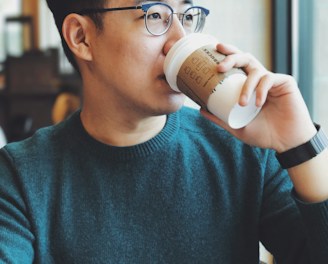 man holding Starbucks disposable cup